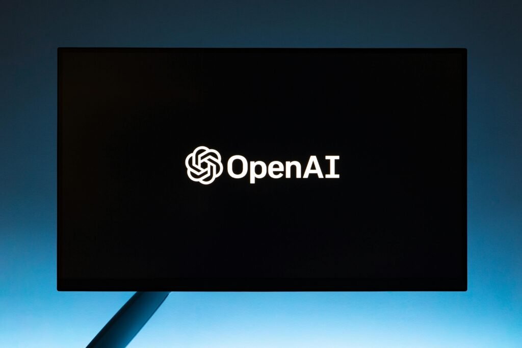 Minimalist display of Codex by OpenAI logo on a screen, set against a gradient blue background.